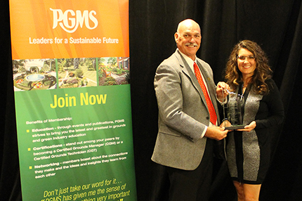 Courtesy of PGMS WCC Landscape and Grounds Maintenance Manager Holly Herman accepts the Grand Award from outgoing PGMS president Marion Bolick.