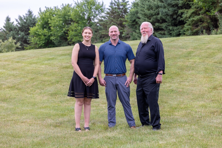 Ryan Reed, Jessica Reed, and Steven Reed standing on a hill together.